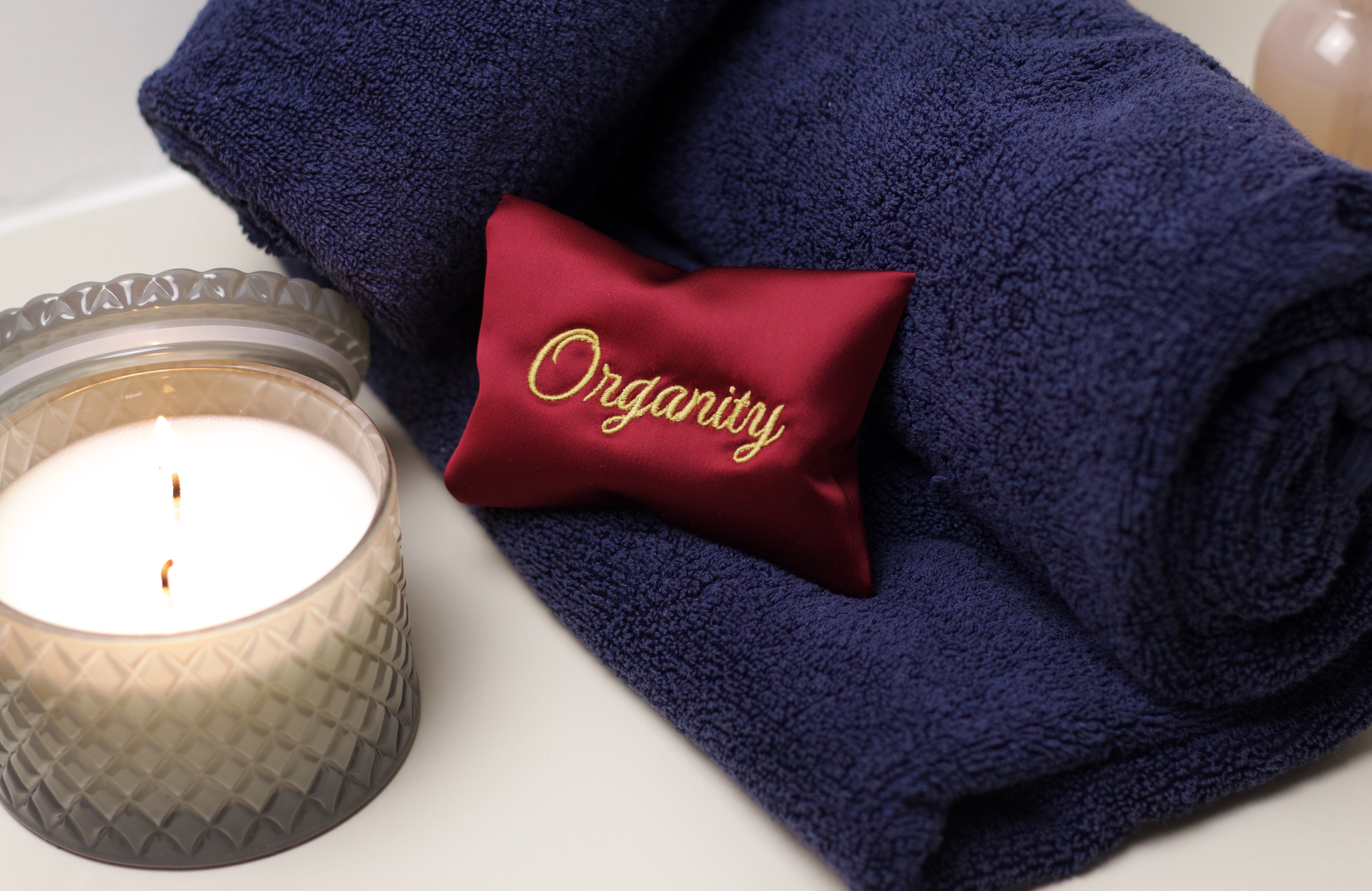 Organity sachet on hotel towel with candle